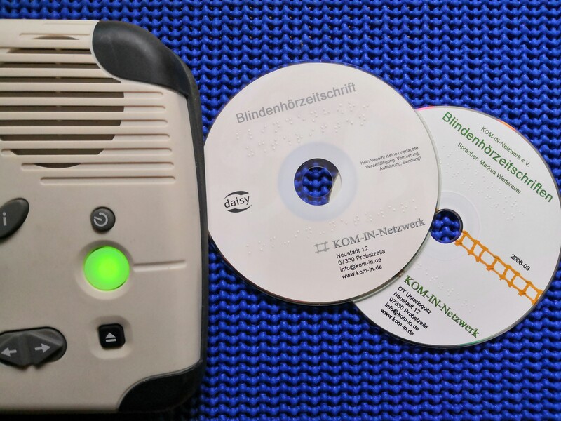 CD's liegen neben einem DAISY-Player, der teilweise zu sehen ist.